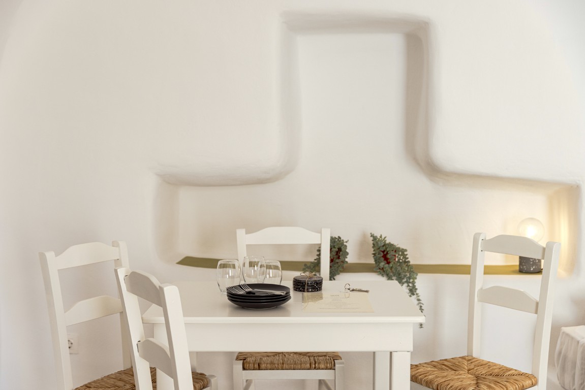 Outdoor seating at Cave Studio balcony in Oia Santorini
